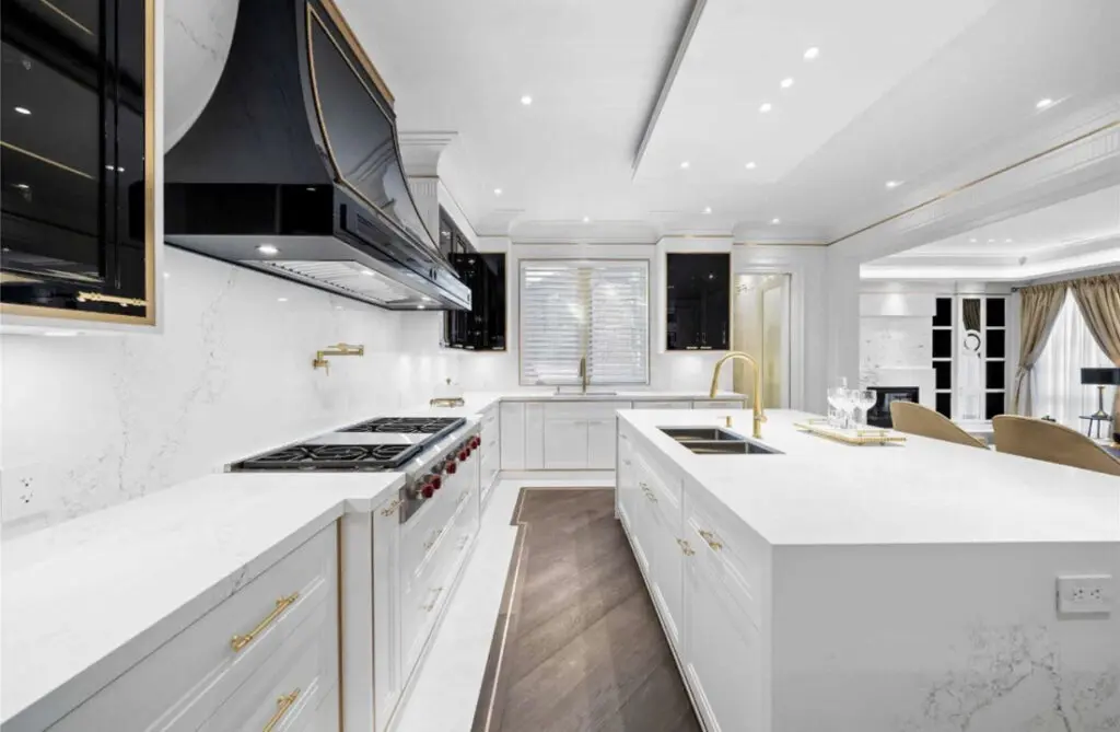 Modern kitchen renovation in Etobicoke with white cabinets and quartz countertops