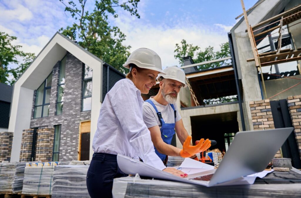 Residential construction team reviewing project plans on site