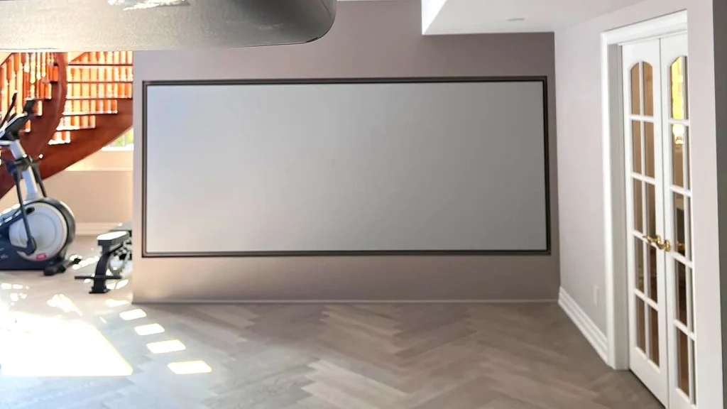 Basement renovation by Renotec showing herringbone flooring and finished basement media area