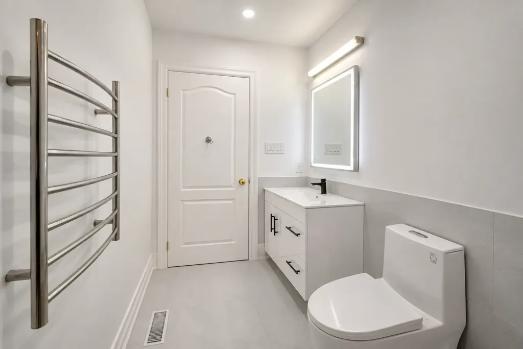 Custom bathroom vanity installation in Toronto with modern mirror and lighting by Renotec
