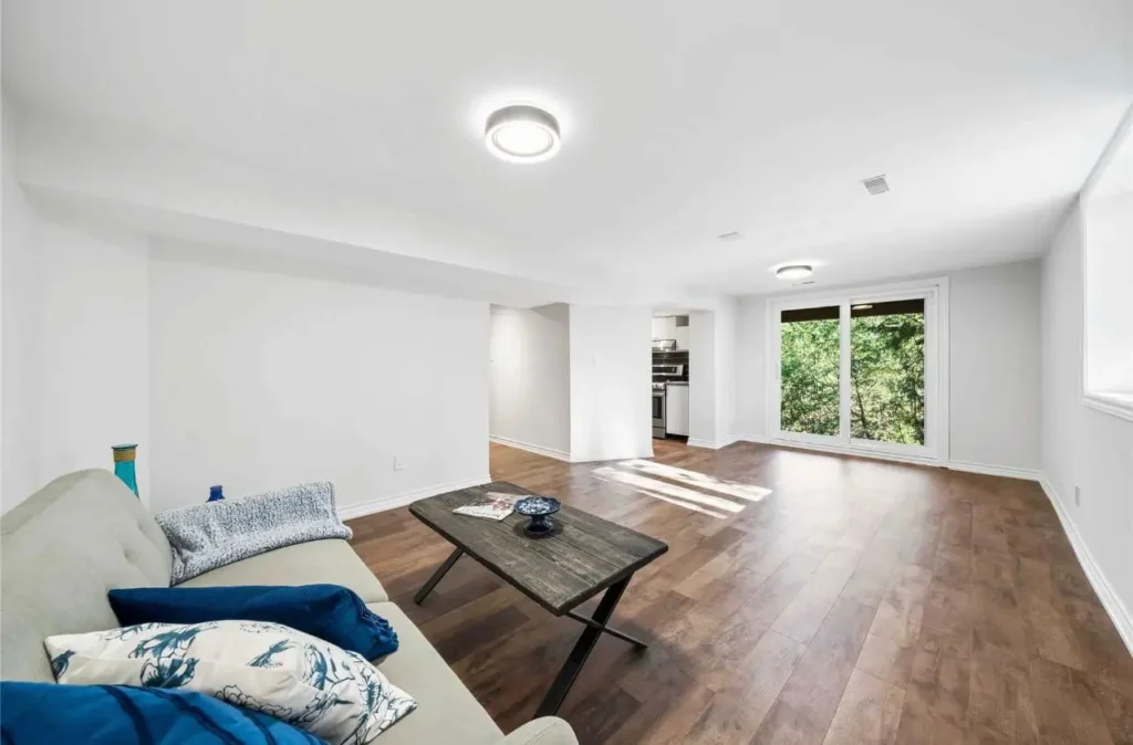 Finished basement family room by Renotec with modern flooring and natural light