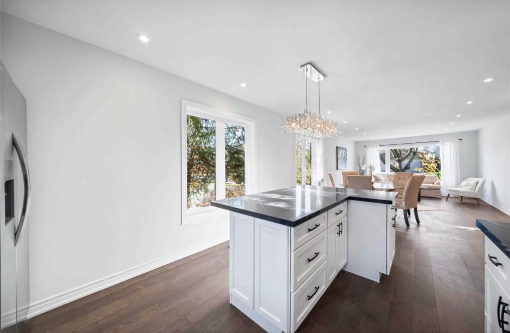Open main floor kitchen renovation in Richmond Hill with island, dining area, and modern lighting